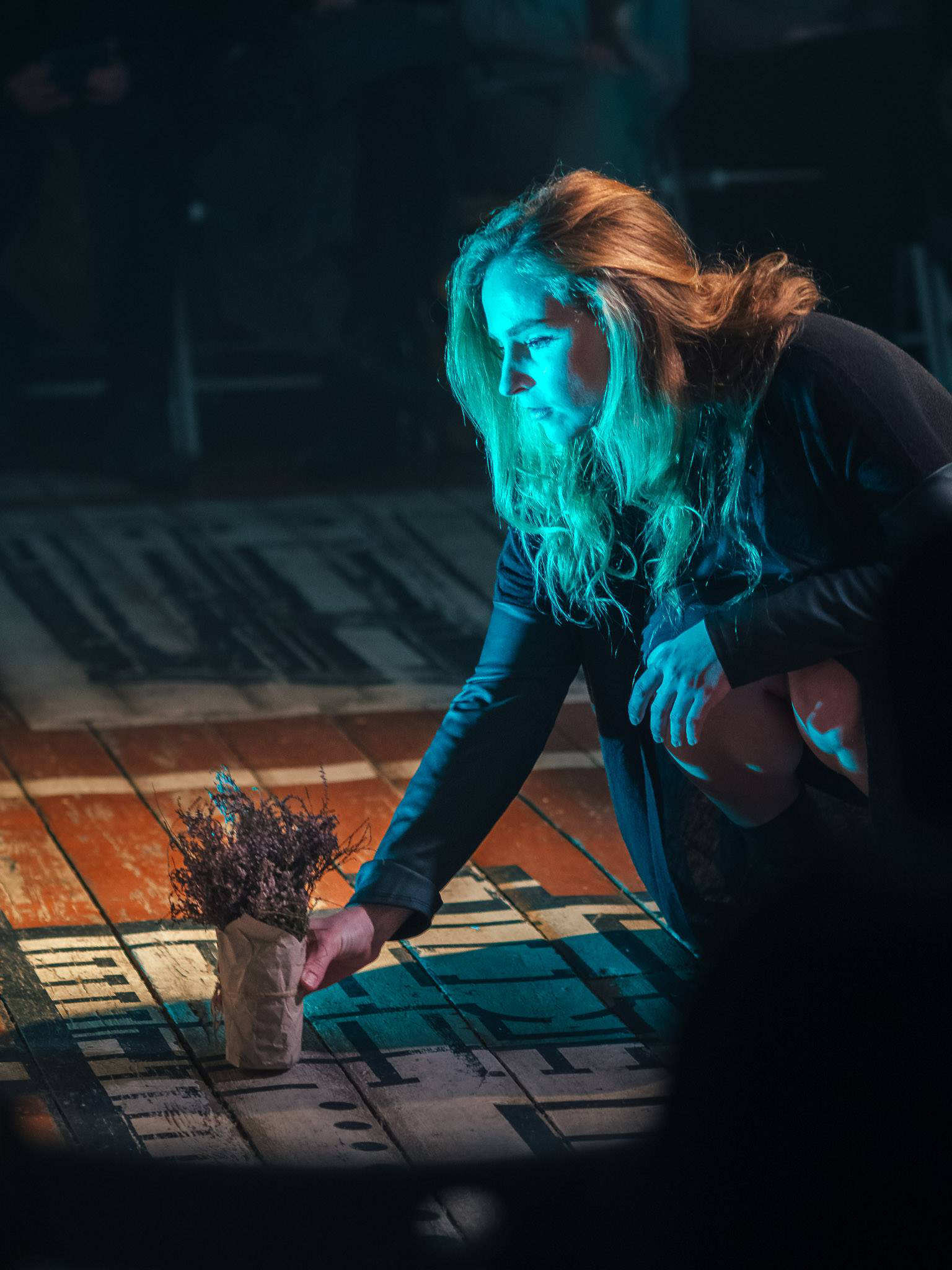 a woman lays flowers in a new Ukrainian play